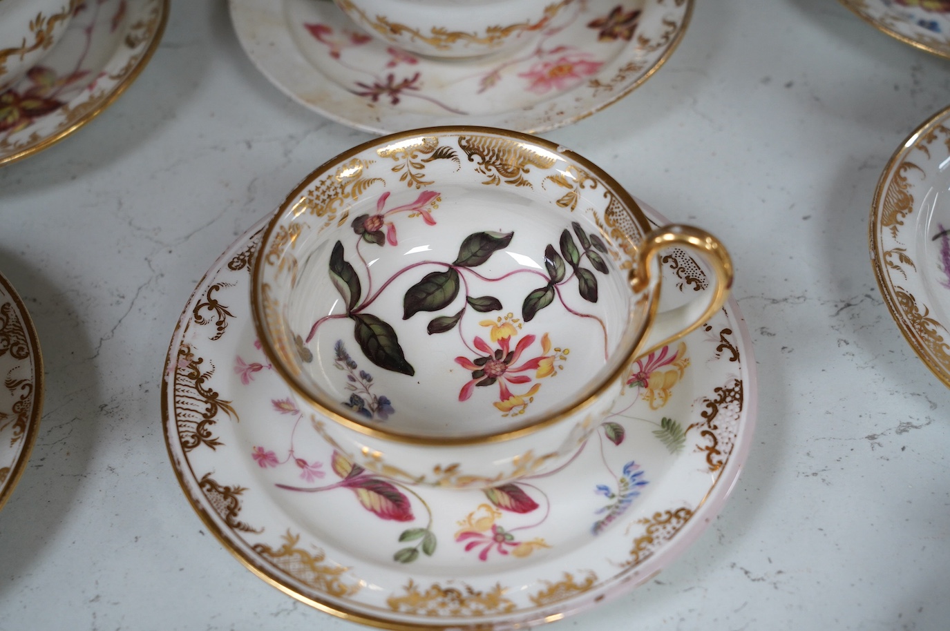 A floral part tea and coffee set, probably Swansea, c.1815-20, largest 23.5cm diameter. Condition - mostly fair